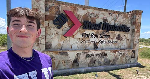 Griffin Lawrence in front of Steel Dynamics signage